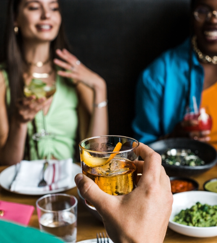 guests enjoying cocktails and food at the source hotel