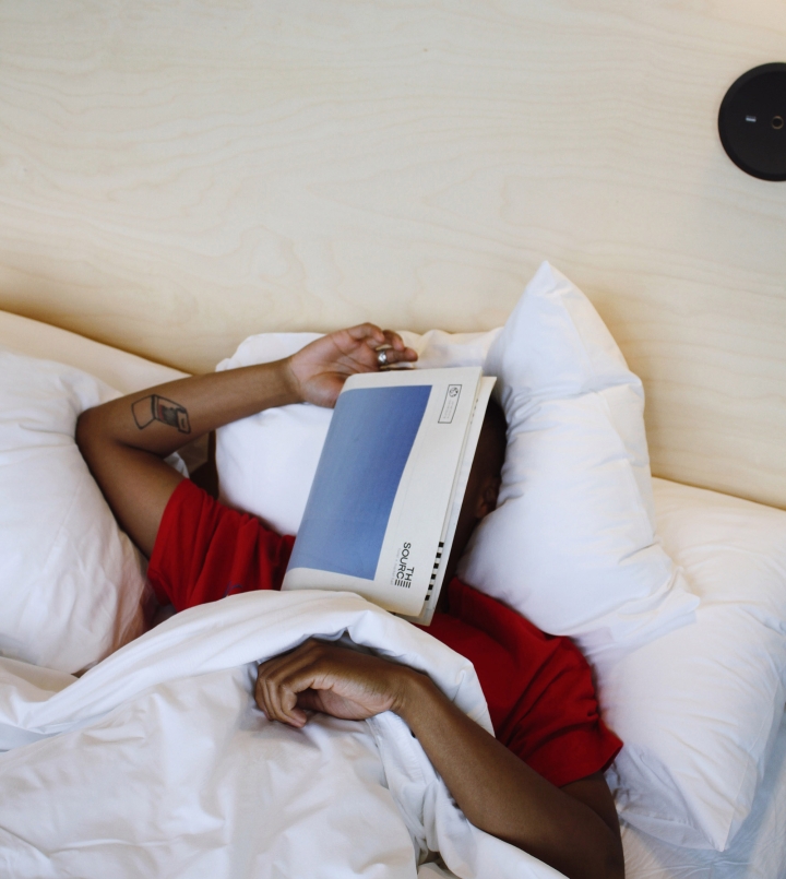 guest in bed at the source hotel
