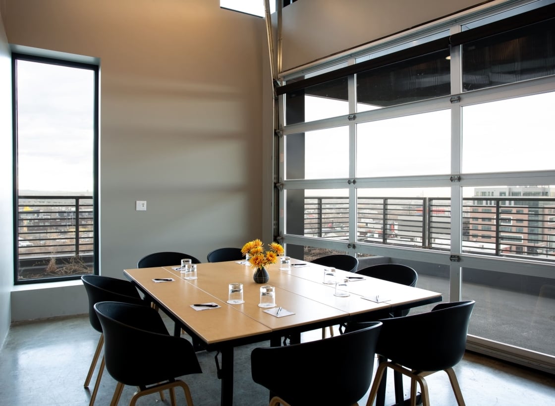 meeting room with large table and chairs around it