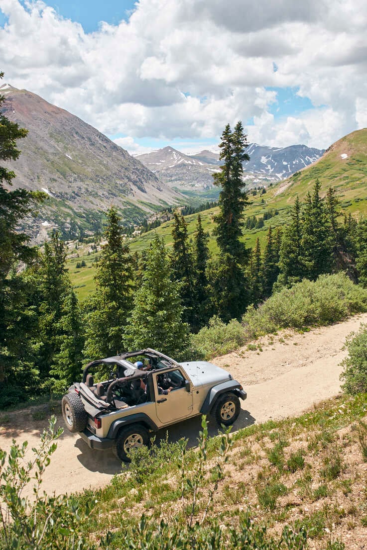 car driving through mountains in the summer