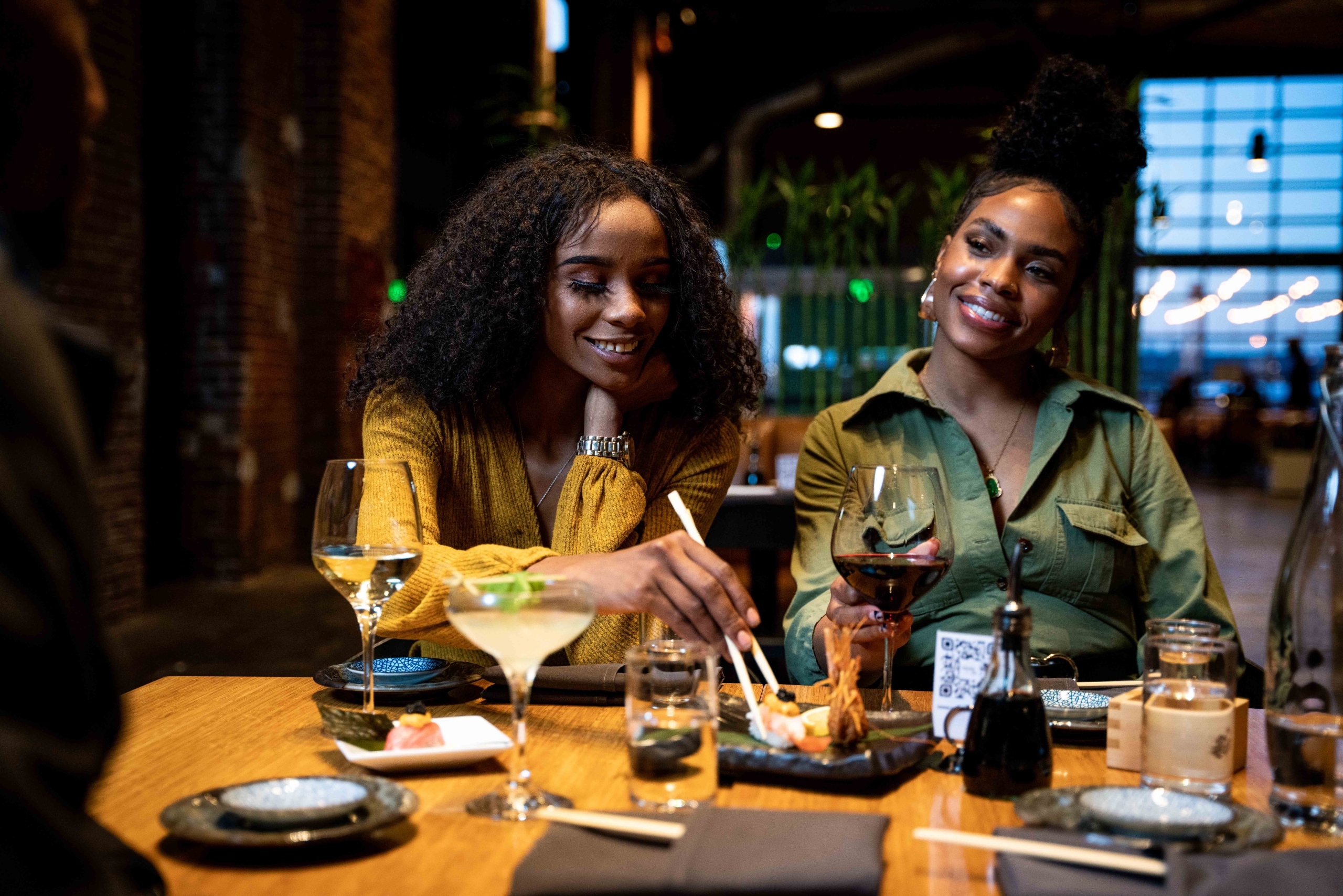 2 people enjoying drinks around a table