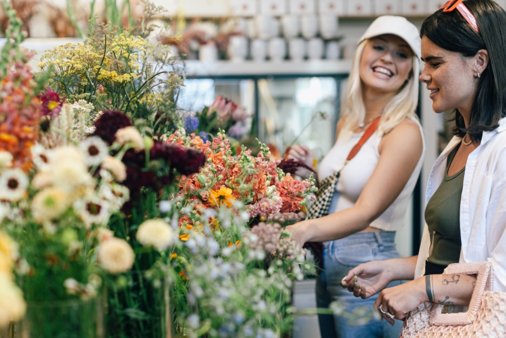 Women looking at flower arrangements