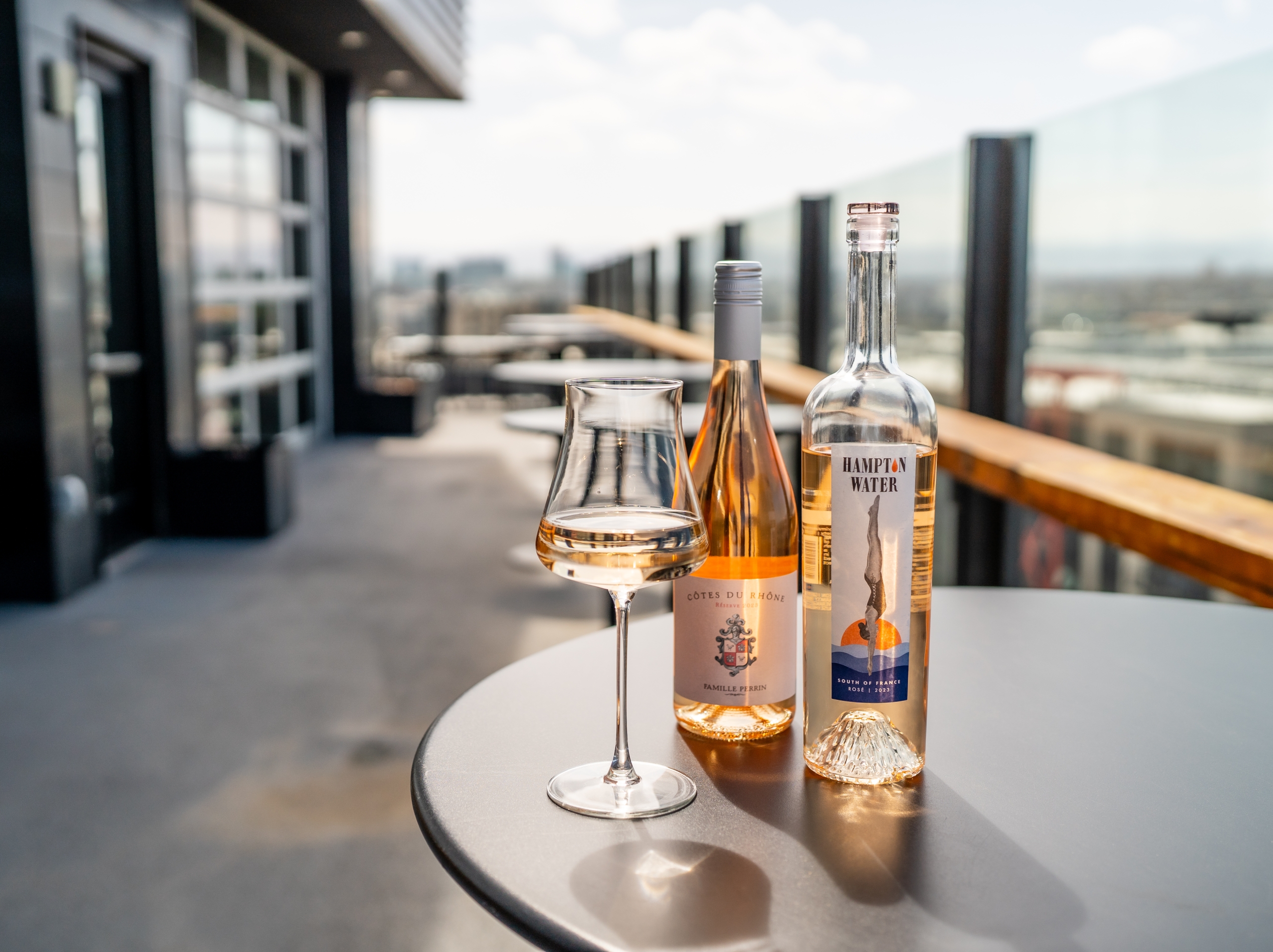 Two bottles of rose on woods restaurant rooftop deck promoting rose all may on wednesdays we drink pink