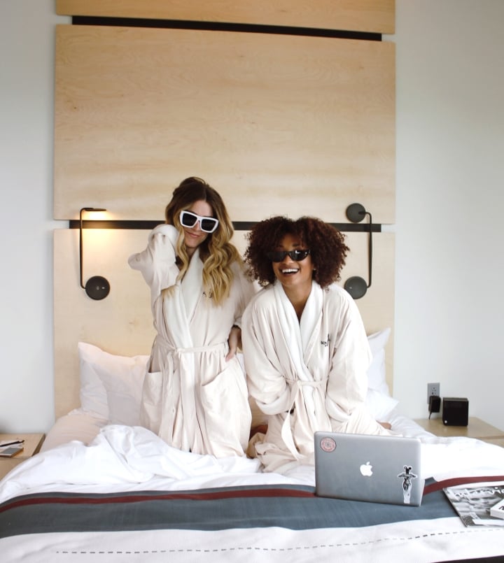 Two-girls-in-bed-with-sunglasses