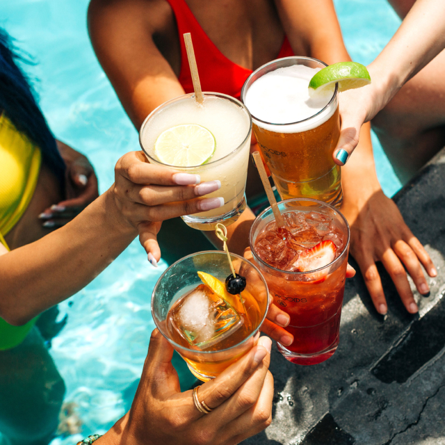 people enjoying cocktails by a pool