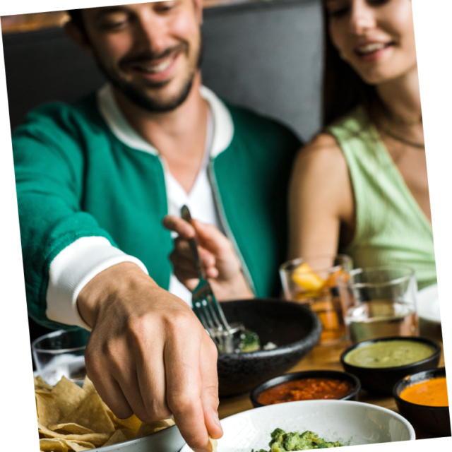 a man and woman eating at a restaurant